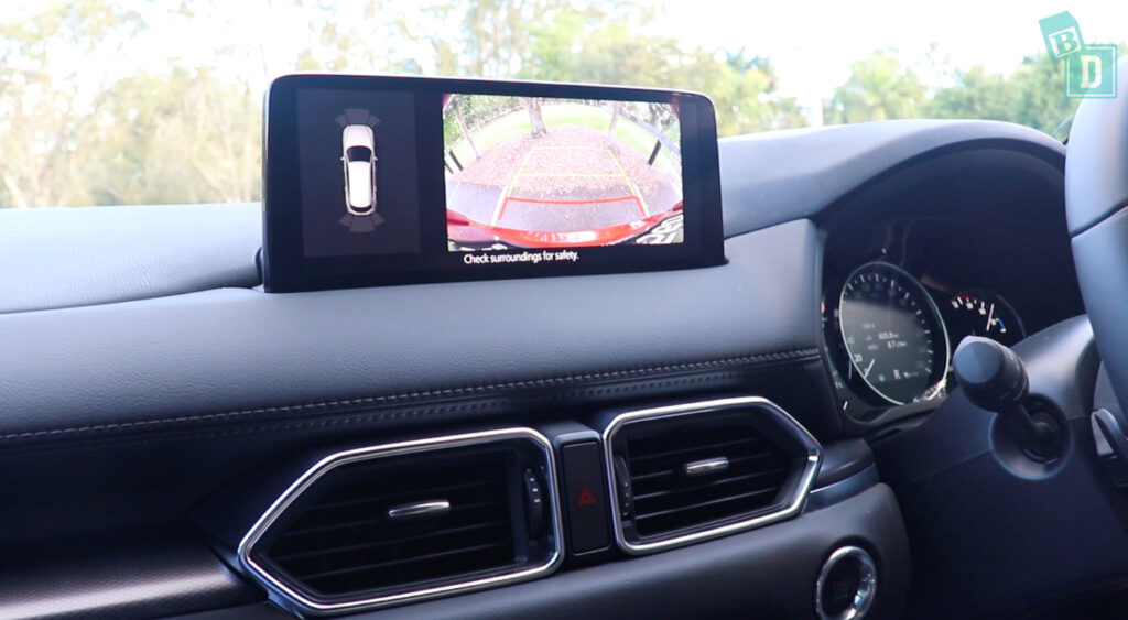 A 2023 Mazda CX-8 with a camera on the dashboard.