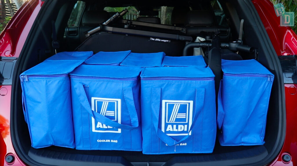 The trunk of a 2023 Mazda CX-8 is filled with blue bags.