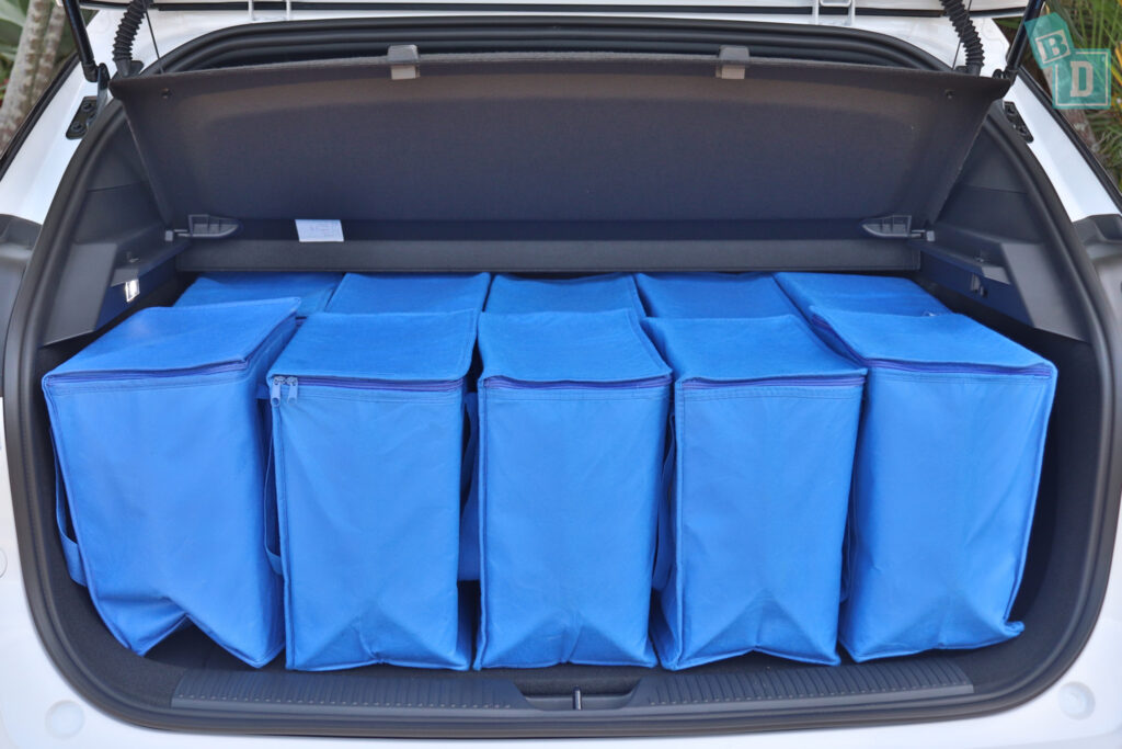 The trunk of a 2023 MG4 is filled with blue bags.