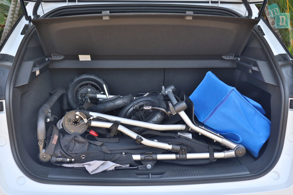 The trunk of a 2023 MG4 with a stroller in it.