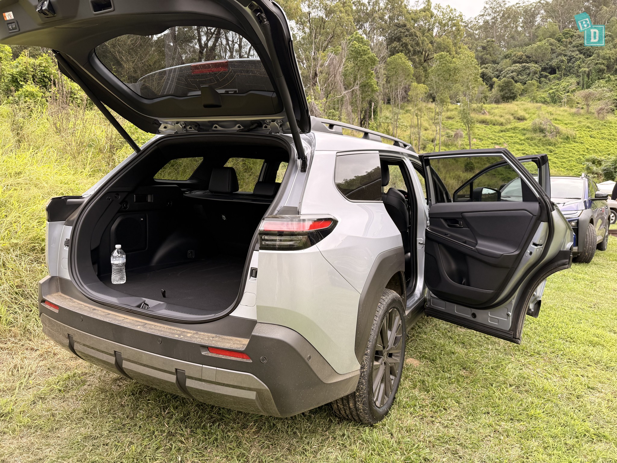 2026 Toyota bZ4X Touring boot open from the rear with rear passenger door also open showing boot floor and load lip